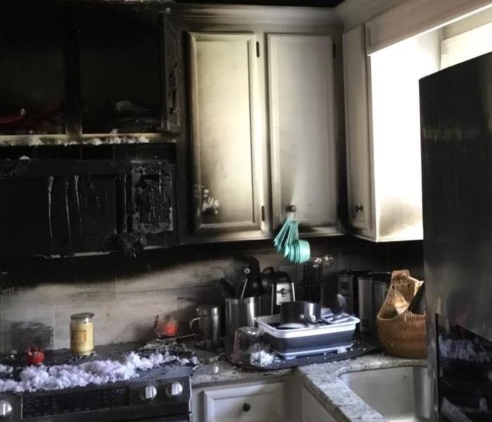 A kitchen is damaged during a grease fire.